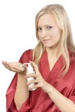 Young Woman Dressed Red Bathrobe With Cream On Her Hand Royalty Free Stock Photography