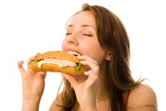 Young Woman Eating A Hot-dog Royalty Free Stock Image