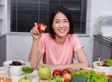 Young woman eating apple in kitchen royalty free stock photo Young woman eating apple in kitchen royalty free stock photo