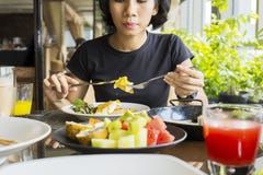 Young woman eating steak in the restaurant Royalty Free Stock Photography Young woman eating steak in the restaurant Royalty Free Stock Photography