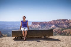 Young woman enjoying nature on a bench stock image Young woman enjoying nature on a bench stock image