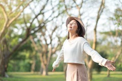 Young woman enjoying morning light in a park Stock Images Young woman enjoying morning light in a park Stock Images