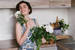 Young woman in fashon dress holding bouquet of beautiful white peonies flowers Royalty Free Stock Photos Young woman in fashon dress holding bouquet of beautiful white peonies flowers Royalty Free Stock Photos