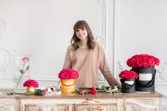 Young Woman Florist Arranging Plants In Flower Shop. People, Business, Sale And Floristry Concept. Bouquet Of Red Roses Royalty Free Stock Photo