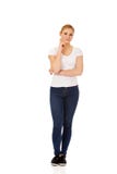 Young woman with folded hands and finger on cheek Royalty Free Stock Photo Young woman with folded hands and finger on cheek Royalty Free Stock Photo