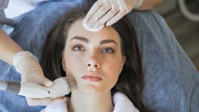 Young woman getting radio frequency lifting procedure in a beauty salon stock video Young woman getting radio frequency lifting procedure in a beauty salon stock video