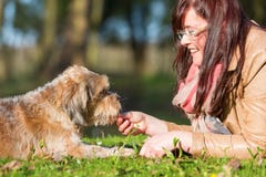 Young Woman Gives Her Dog A Treat Stock Photography