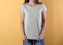 Young woman in grey t-shirt on color background royalty free stock image Young woman in grey t-shirt on color background royalty free stock image