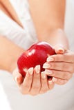 Young woman holding red apple. In her hands, on white Stock Photography Young woman holding red apple. In her hands, on white Stock Photography