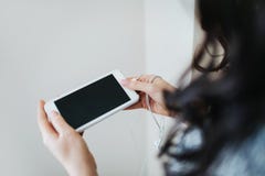 Young woman holding white smartphone. royalty free stock photos Young woman holding white smartphone. royalty free stock photos