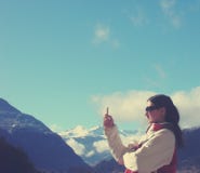 Young Woman In Winter Clothes Texting On Mobile Phone; Retro Style Royalty Free Stock Images Young Woman In Winter Clothes Texting On Mobile Phone; Retro Style Royalty Free Stock Images