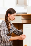 Young Woman Is Assembling A Cupboard Stock Photography