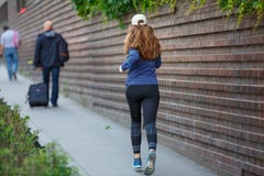 Young woman jogging along street in european city Royalty Free Stock Image Young woman jogging along street in european city Royalty Free Stock Image