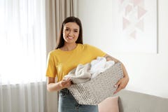 Young woman with laundry basket full of clean towels royalty free stock photography Young woman with laundry basket full of clean towels royalty free stock photography