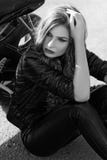 Young woman in leather clothes near a motorcycle. Black and white photo royalty free stock photo Young woman in leather clothes near a motorcycle. Black and white photo royalty free stock photo