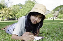 Young Woman Lies On Green Summer Meadow With Book Royalty Free Stock Photos