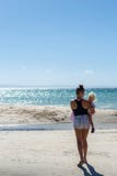 Young woman with little blonde baby walking by the sea in Philippines stock photos Young woman with little blonde baby walking by the sea in Philippines stock photos