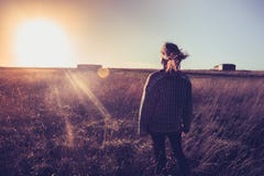 Young Woman Looking At Sunset In Field With Her Hair Blowing Stock Images Young Woman Looking At Sunset In Field With Her Hair Blowing Stock Images