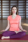 Young woman in the lotus position while meditating royalty free stock photography Young woman in the lotus position while meditating royalty free stock photography