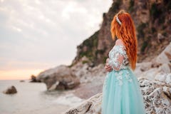 Young woman in a luxurious dress stands on the shore of the Adriatic Sea royalty free stock image Young woman in a luxurious dress stands on the shore of the Adriatic Sea royalty free stock image
