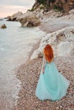 Young woman in a luxurious dress stands on the shore of the Adriatic Sea royalty free stock photography Young woman in a luxurious dress stands on the shore of the Adriatic Sea royalty free stock photography