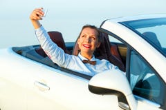 Young woman making self portrait sitting in the cabriolet stock photos Young woman making self portrait sitting in the cabriolet stock photos