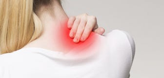 Young woman massaging her sore neck, panorama stock photo Young woman massaging her sore neck, panorama stock photo