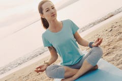 Woman meditating in lotus position on shore. Royalty Free Stock Photography Woman meditating in lotus position on shore. Royalty Free Stock Photography