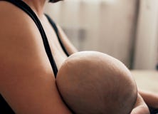 Young Woman Mother Breastfeeding Her Baby, Motherhood Natural Feeding Concept Royalty Free Stock Image