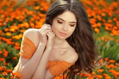 Young woman outdoors portrait over orange marigold flowers Royalty Free Stock Image Young woman outdoors portrait over orange marigold flowers Royalty Free Stock Image