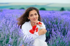Young woman with poppy is in the lavender flower field, beautiful summer landscape stock photo Young woman with poppy is in the lavender flower field, beautiful summer landscape stock photo