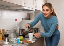 Young Woman preparing coffee in the kitchen stock image Young Woman preparing coffee in the kitchen stock image