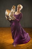 Young woman in purple dress dancing with antique carousel horse. Stock Image Young woman in purple dress dancing with antique carousel horse. Stock Image