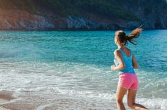 Young woman running on the beach stock photos Young woman running on the beach stock photos