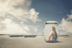 Young woman sitting in a jar in the desert. Loneliness outlier concept