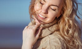 A young woman is smiling holding her hand on her collar stock photos A young woman is smiling holding her hand on her collar stock photos