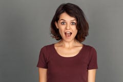 Freestyle. Young woman isolated on grey screaming excited close-up stock photography Freestyle. Young woman isolated on grey screaming excited close-up stock photography