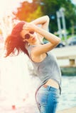 Young woman with sunglasses in blue jeans summer day in city wind in hair stock photography Young woman with sunglasses in blue jeans summer day in city wind in hair stock photography