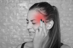 Young woman with a terrible headache Stock Images Young woman with a terrible headache Stock Images