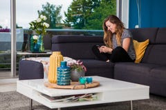 Young woman texting and chilling on the couch royalty free stock image Young woman texting and chilling on the couch royalty free stock image