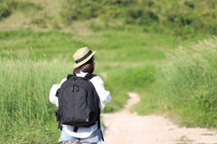 Young woman traveler with backpack enjoying and standing on the road of the mountains background, Koh Larn in Pattaya city, royalty free stock photos Young woman traveler with backpack enjoying and standing on the road of the mountains background, Koh Larn in Pattaya city, royalty free stock photos