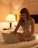 Young woman using laptop in hotel