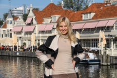 Young woman waiting for tour boat in Amsterdam, the Netherlands Stock Image Young woman waiting for tour boat in Amsterdam, the Netherlands Stock Image