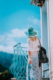 Young woman wearing summer clothes and straw hat going up stairs on sunny day. Vacation holidays in Europe stock photo Young woman wearing summer clothes and straw hat going up stairs on sunny day. Vacation holidays in Europe stock photo