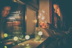 Young woman who lights fireworks at home royalty free stock photos Young woman who lights fireworks at home royalty free stock photos