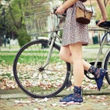 Young Woman With Bicycle Stock Photography