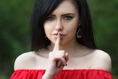 Young Woman With Dark Long Hair Saying Shh With Forefinger On Lips. Silence Gesture Stock Photos