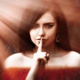 Young Woman With Dark Long Hair Saying Shh With Forefinger On Lips. Silence Gesture Stock Photography