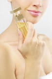 Young Woman With Perfume On Gray Stock Image