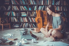 Young woman writer in library at home creative occupation no inspiration stock images Young woman writer in library at home creative occupation no inspiration stock images
